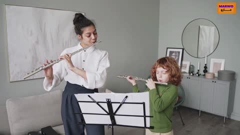 A little girl and her mother playing the flute