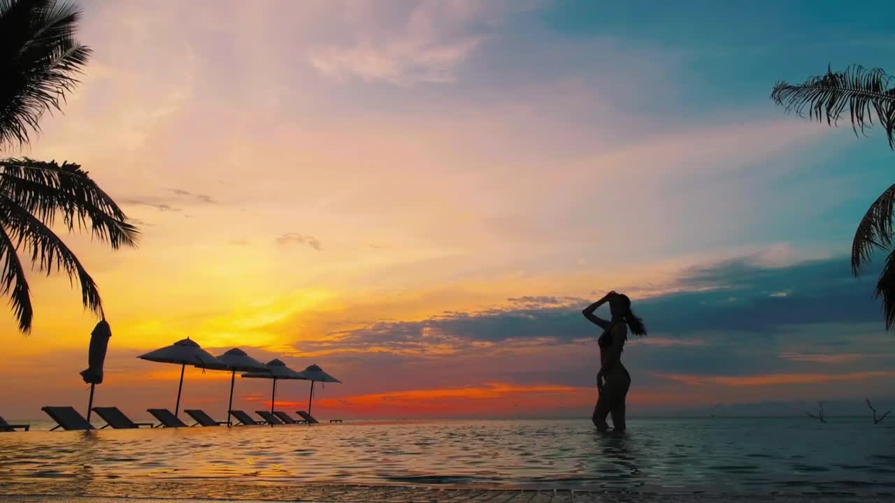 Woman in a pool at sunset