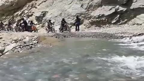 bike passing through flowing river,ladakh