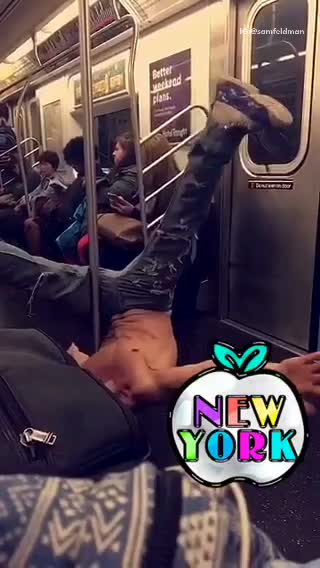 Shirtless guy subway upside down slide pole