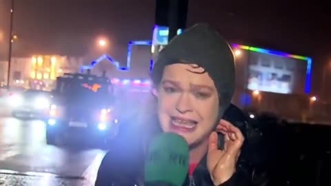 Reporter Gets Slammed By Stop Sign During Storm