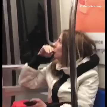 Woman sucks on her potato chip on subway train