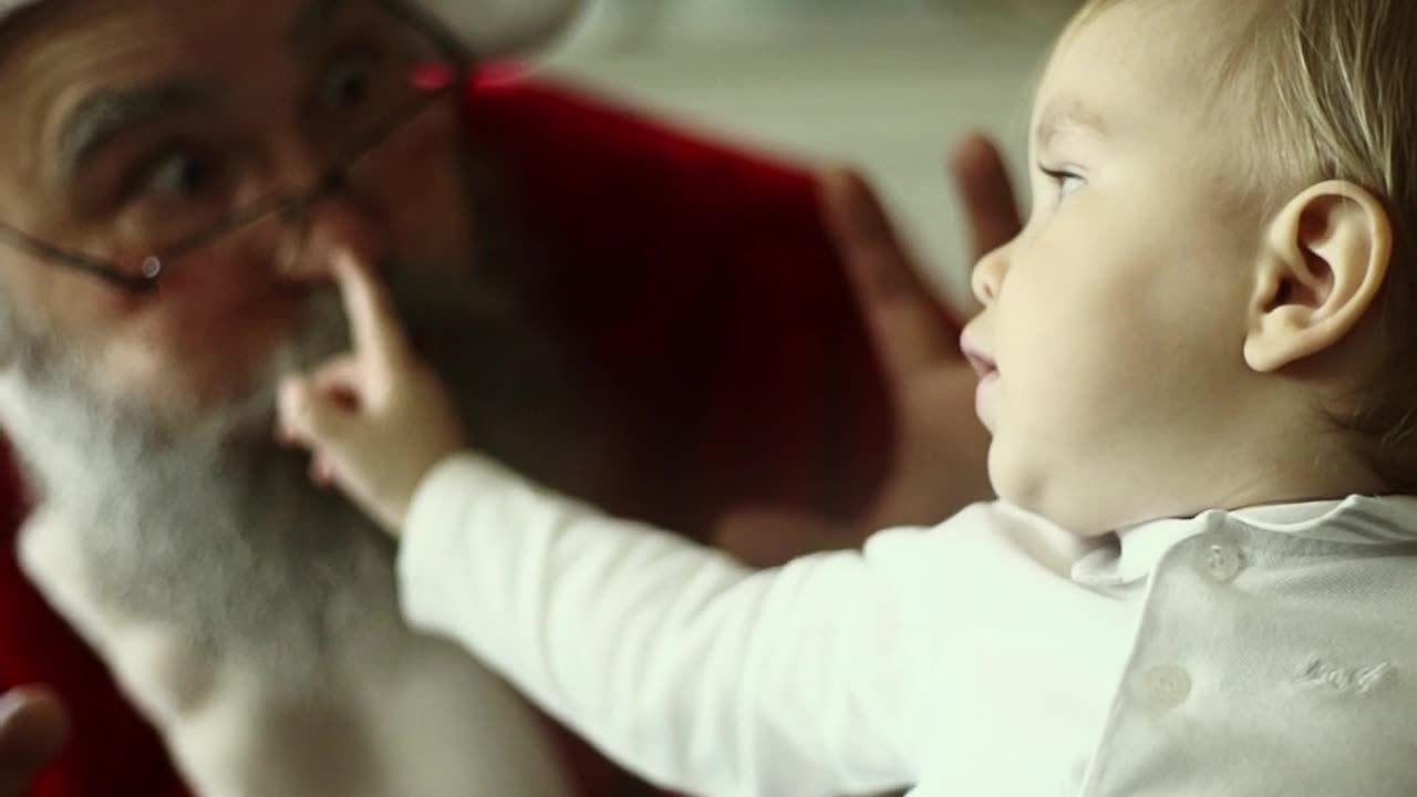 baby playing with Santa Claus 🎅