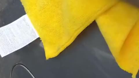 There are some mud stains on the car after the rain. A towel will do