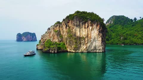 Rocks sea islands boats water sky