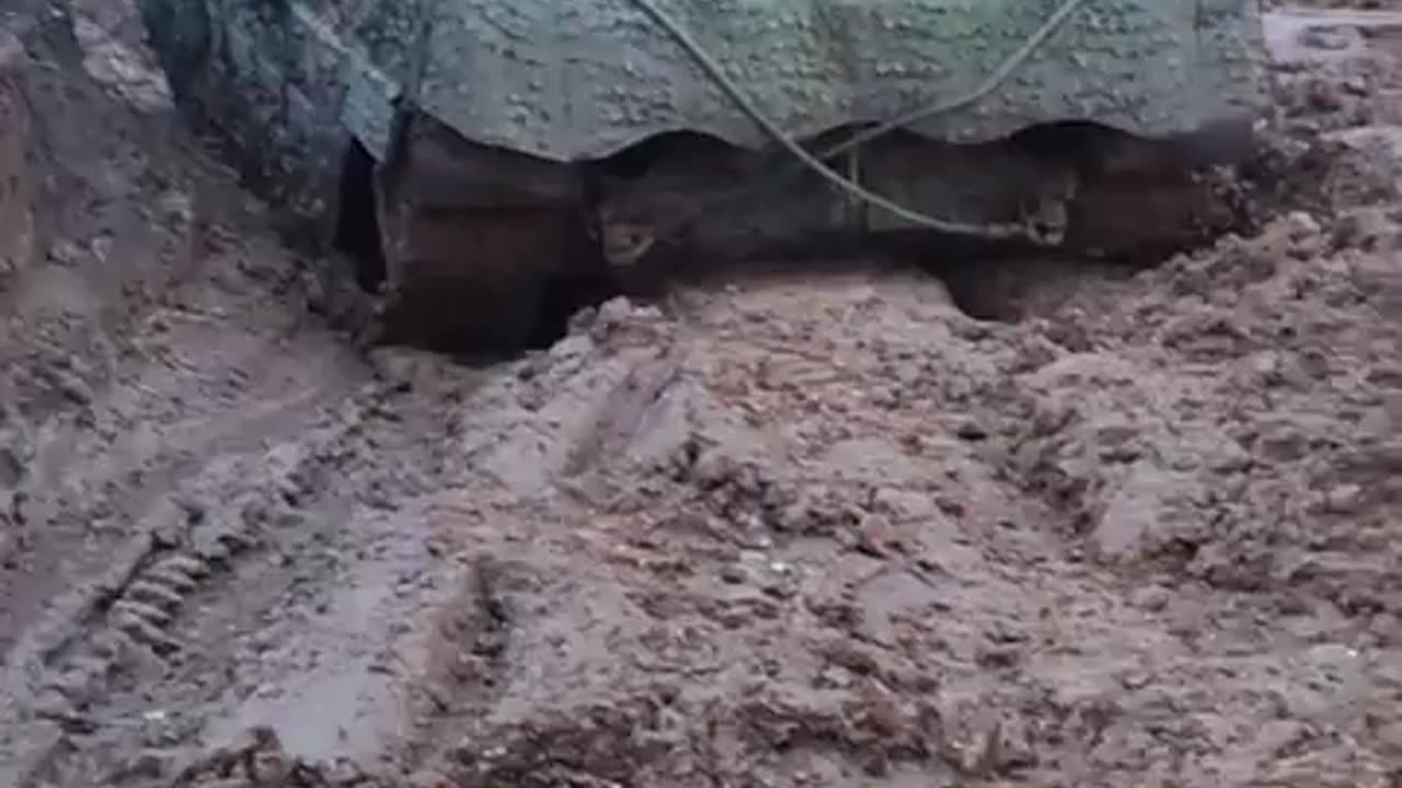 Ukrainians in a Swedish Tank STRV 122 struggling in the muddy terrain in the war zone