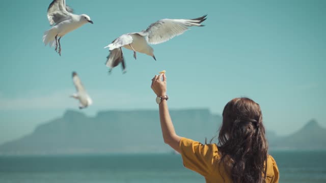 Woman Feeding a Bird