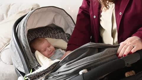 mother-comforting-baby-in-stroller