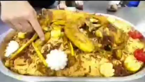 Very delicious meat Mandi with roasted lambonion tomato presented on it looks very delicious amazing