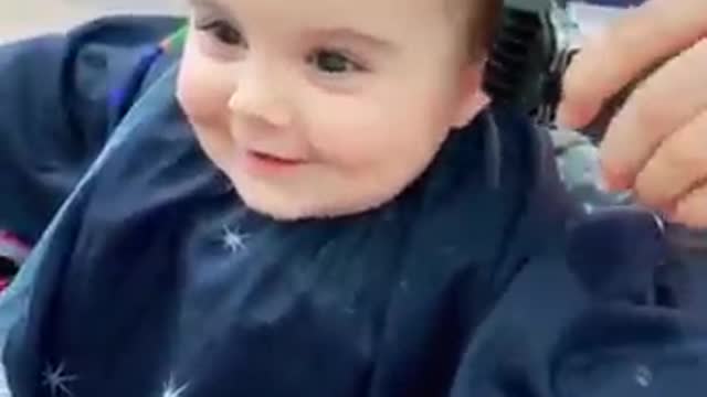 Cute baby getting haircut.