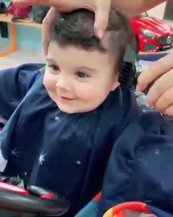 Cute baby getting haircut.