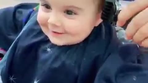 Cute baby getting haircut.