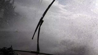 Waves Crash over Road During Storm Surge