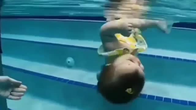 The baby floating in the swimming pool