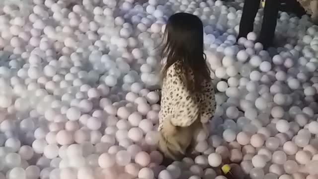 Children playing in the kids cafe ball pool