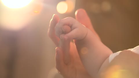 Mother Holding Baby's Hand