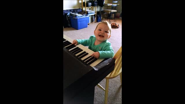 Baby extremely amused by piano playing