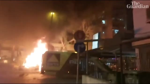 Israeli airstrikes demolish tower block and Hamas rocket hits bus as violence escalates