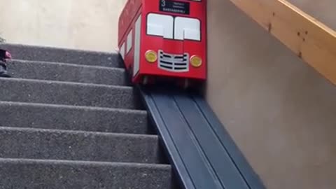 Bulldog puppy rides the stair lift like a boss