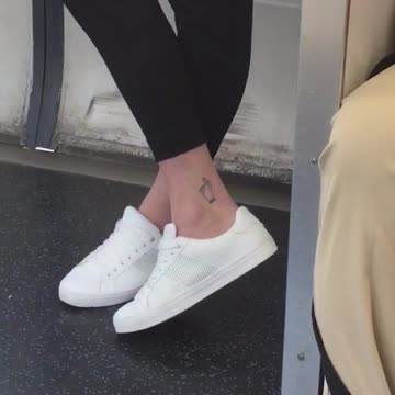 Guy black pants white shoes got em finger game tattoo