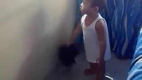 A cute one -year -old baby is already helping clean the house