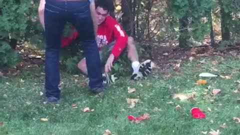 Guy jumping on top of another guy in bushes