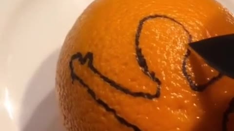 An image cut out of an orange peel has its manhood sticking out