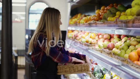 Female Worker In Black Apron Arranging Apples In Supermarket