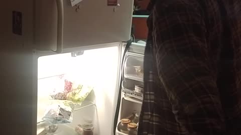 Guy tries to move fridge on back fails