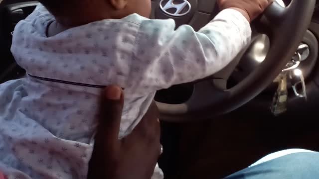 My little boy is driving a car