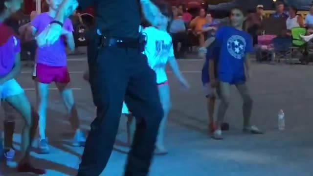 Officer Boogies with Kids at Street Party