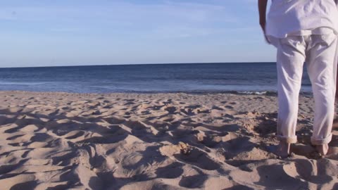 A couple on the beach during a sunset. Stock footage