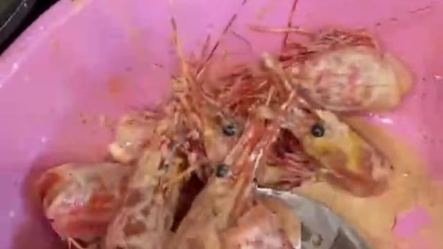 Red shrimp head covered with flour and deep fried .