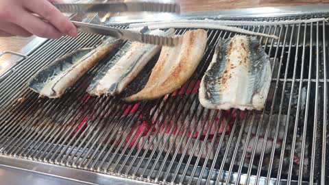 Broiled eel, the process of cooking eel.