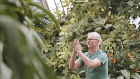 Man Doing Yoga in a Botanical Garden