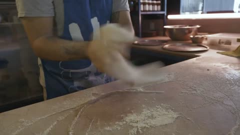 Chef's hands preparing dough