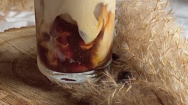 SATISFYING POURING MILK INTO COFFEE