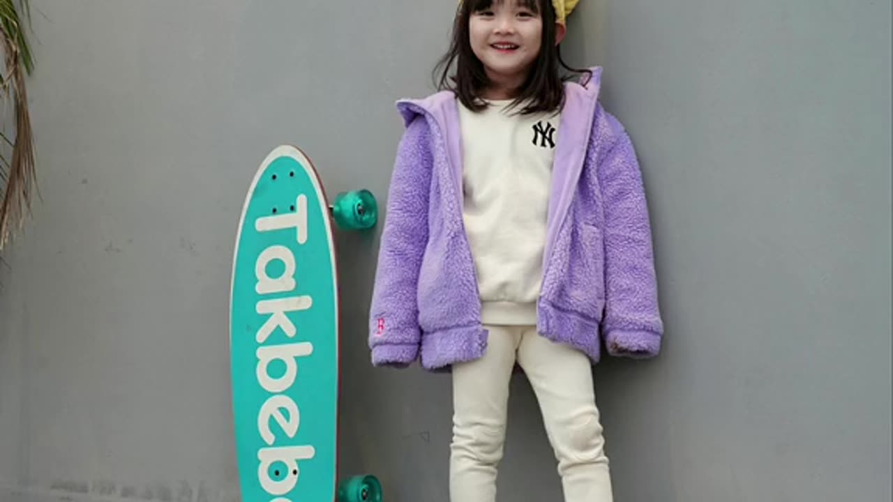 cute baby playing skateboard