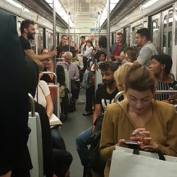 Guy in black shirt performs trick on train