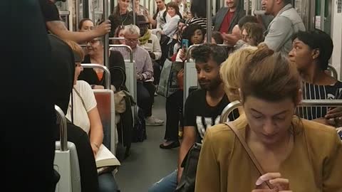 Guy in black shirt performs trick on train