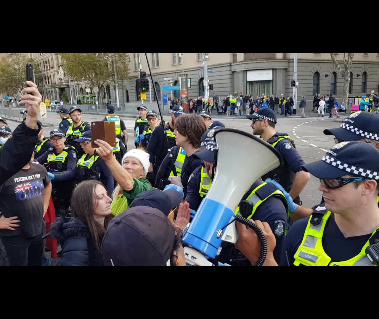 Police violently attack and push elderly man backwards onto the road.