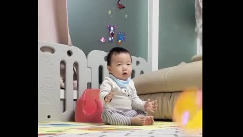 a baby playing with a ball