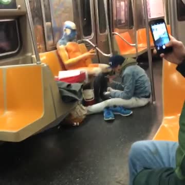 Guy green sweater photoshoot subway person paint seats