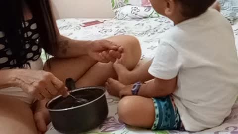 child eating chocolate with grandma