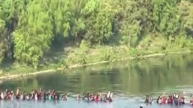 Massive migrant group crosses river into US as border crisis spirals out of control.