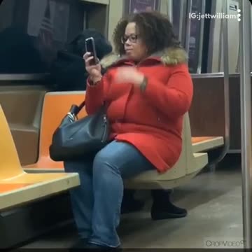 Woman orange coat big hair taking selfies