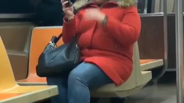 Woman orange coat big hair taking selfies