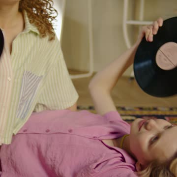 Women Using Vinyl Records as Fans
