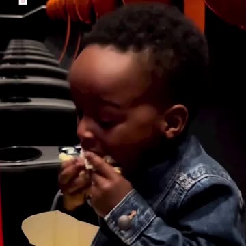 The intense way this kid eats popcorn at the movie theater is blowing our minds