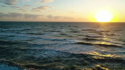 Foamy waves of the sea crashing with a coastline